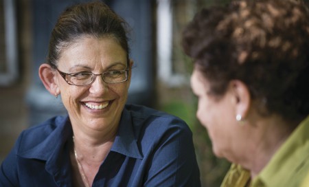 Woman smiling and talking to another woman