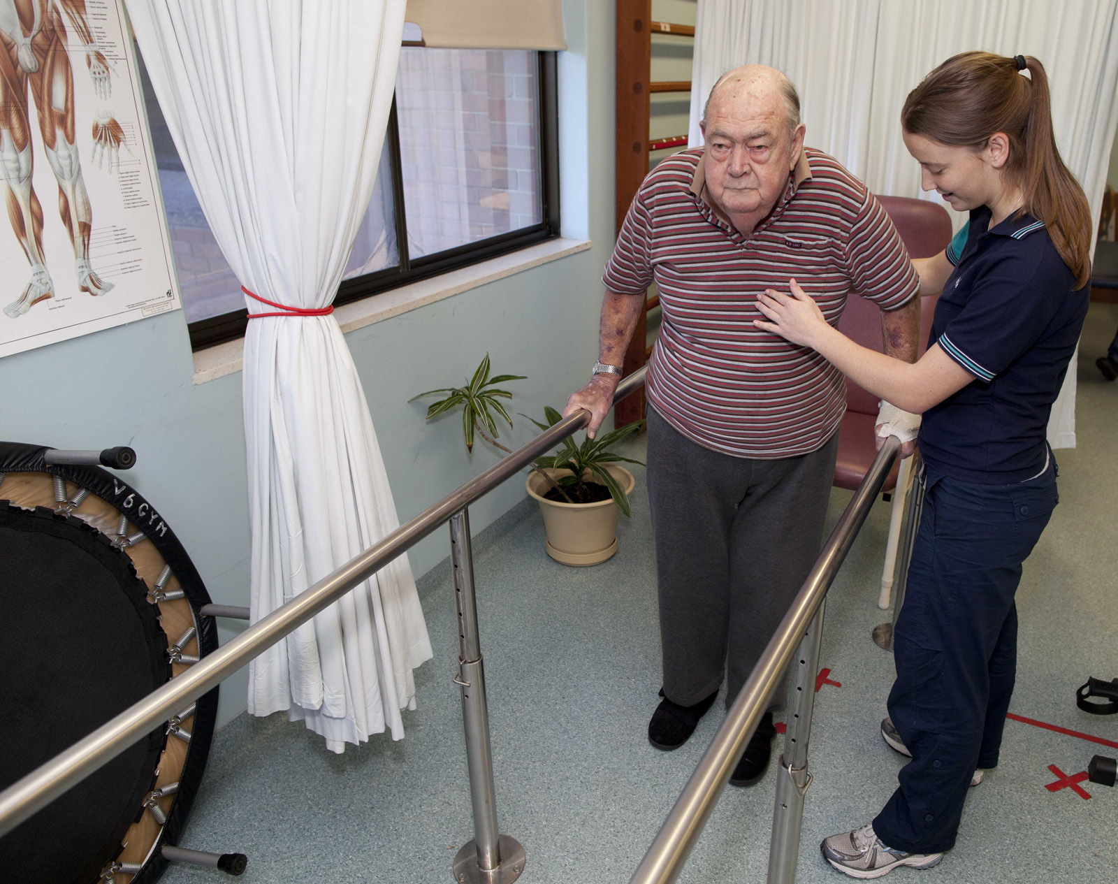 Patient practising walking with the help of a physiotherapist